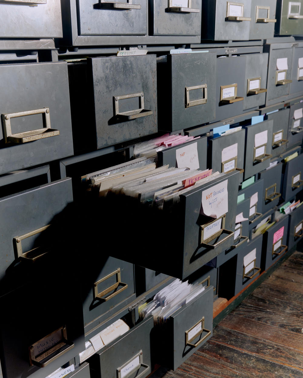 Filing cabinets organizing postcards by subject line the inside of Brown's home.
