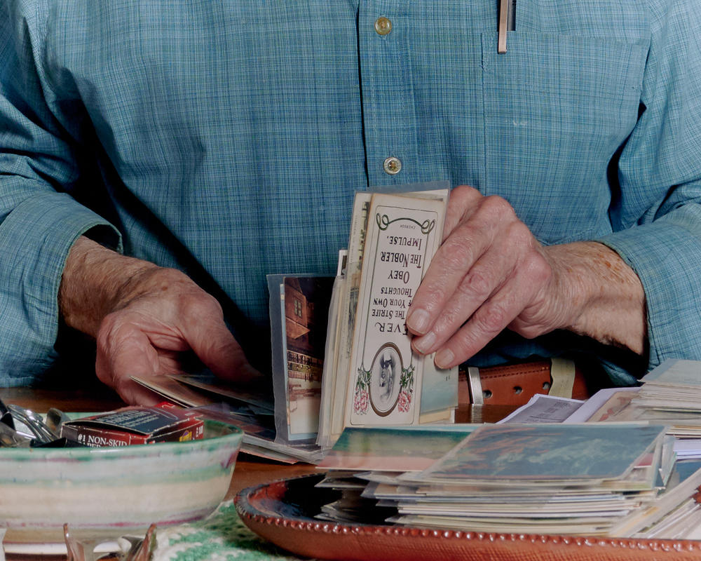 Brown organizes postcards in his home.