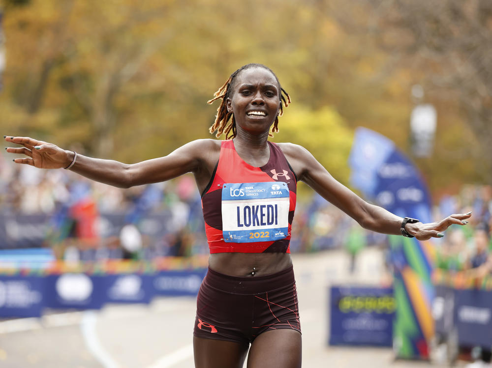 Sharon Lokedi, of Kenya, crosses the finish line first in the women's division of the New York City Marathon on Sunday.