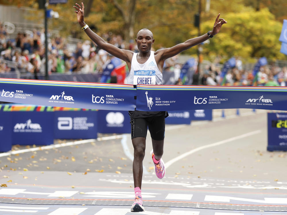 Evans Chebet, of Kenya, crosses the finish line first in the men's division of the New York City Marathon on Sunday.