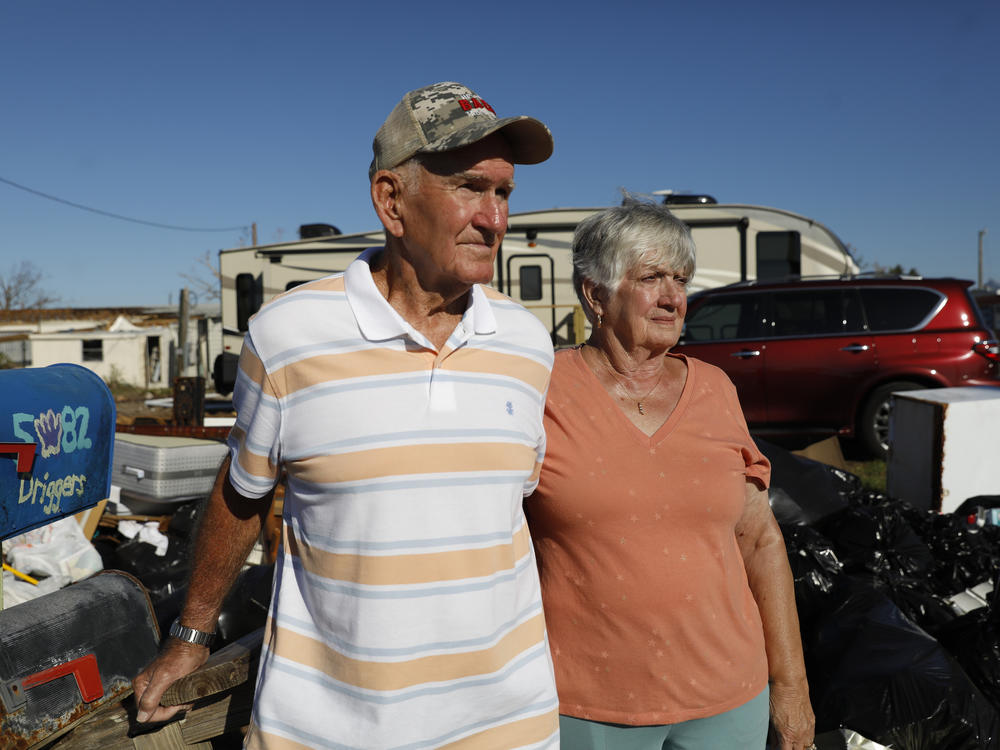 Jimmy Driggers and his wife Shirley pose for a portrait on Oct. 28, 2022 in Pine Island, Fla., where their home was severely flooded by a storm surge from Hurricane Ian in September.
