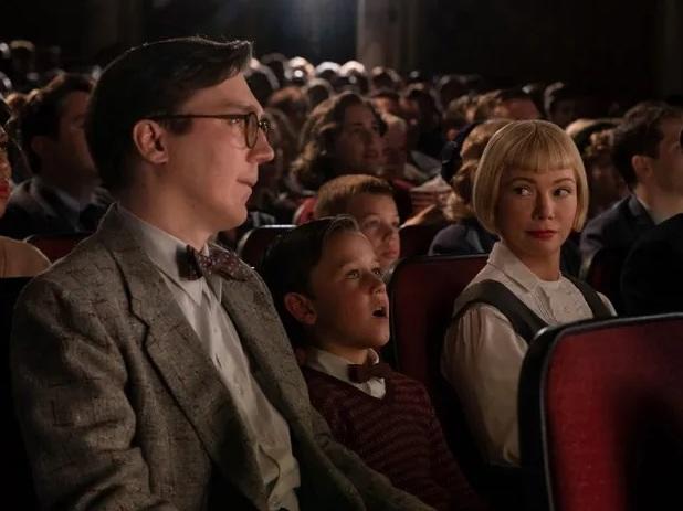 Young Sammy (Mateo Zoryon Francis-DeFord) experiences the magic of the movies with his parents (Paul Dano and Michelle Williams) in <em>The Fabelmans</em>.