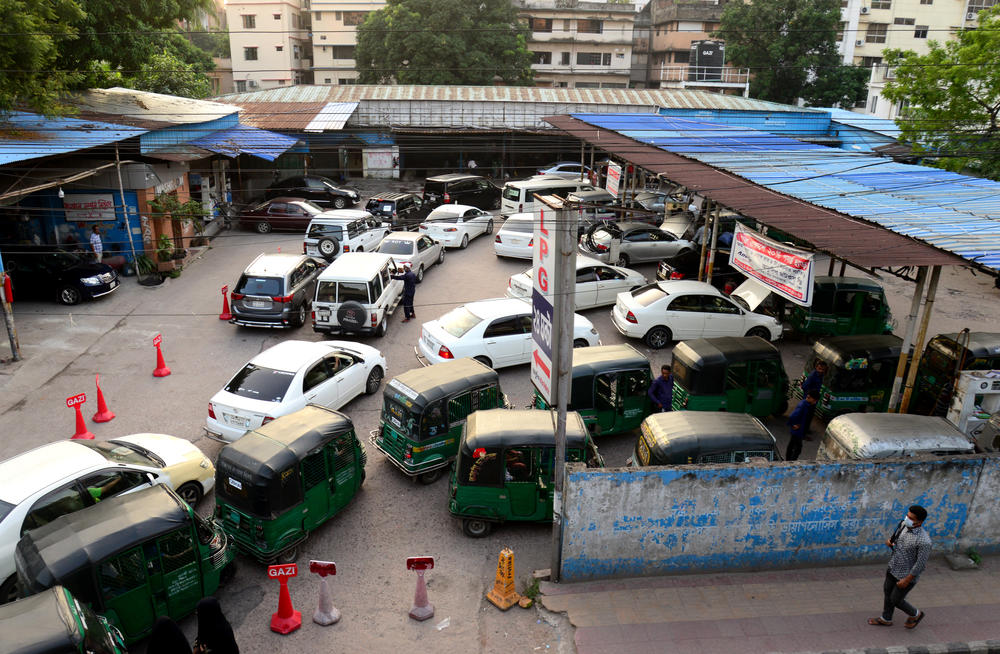 Vehicle drivers queue to refill their vehicles with compressed natural gas at a CNG station in Dhaka on Oct. 15.