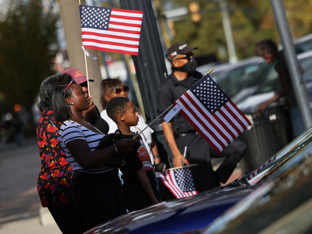 People look on during the Cherry Blossom Festival Veterans Day Parade Sunday in Macon, Ga. Georgia's Senate race, which could decide control of the Senate, might not be resolved for a month.