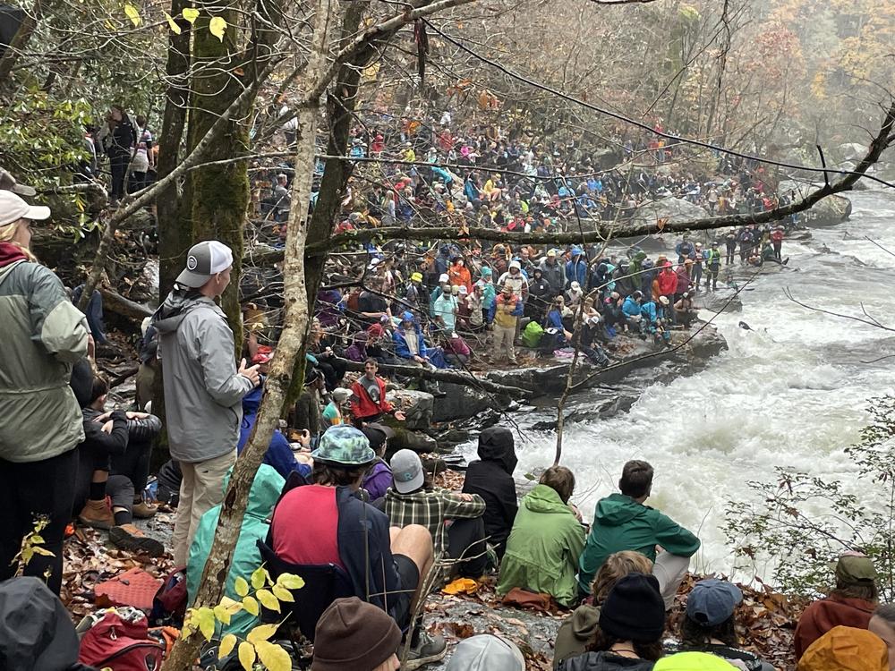 People crowd the steep banks of the Green River near Saluda, N.C., to watch participants in the Green Race, an event that organizers claim is the largest extreme kayak race in the world.
