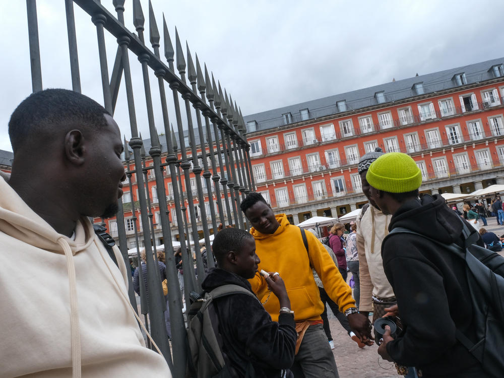 Four young men from Senegal sell bracelets in Madrid on October 20.