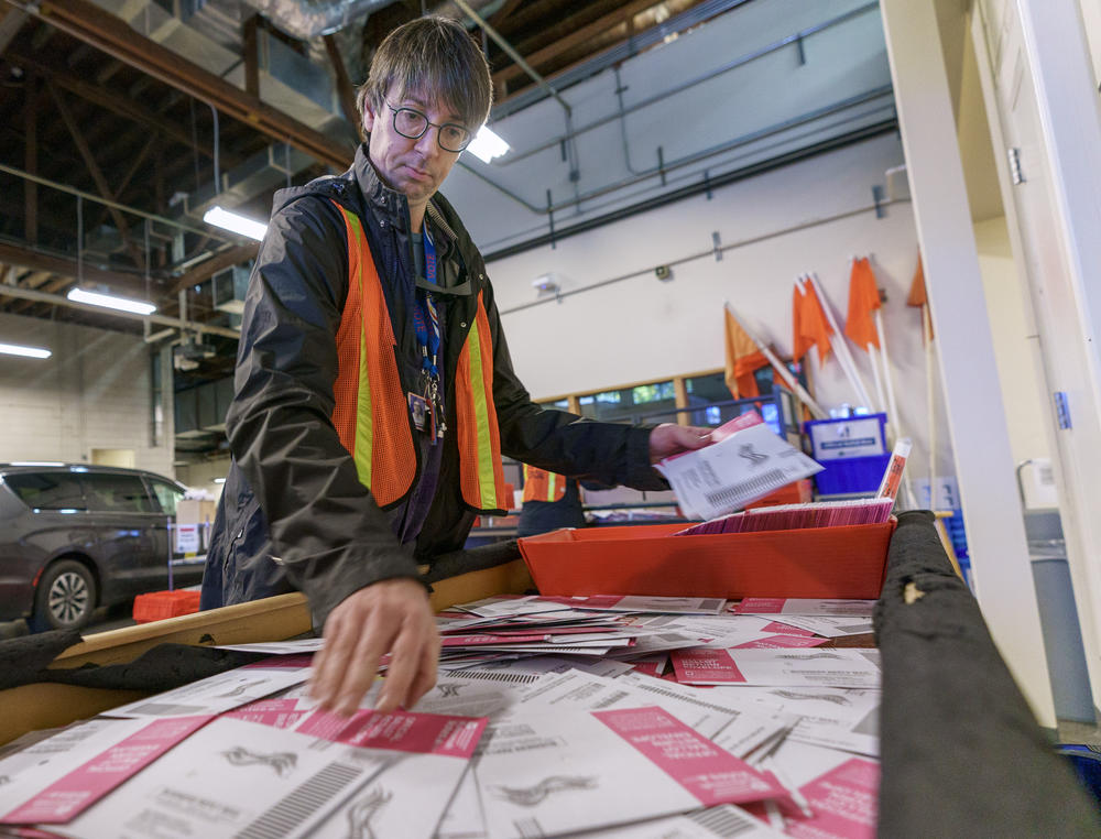 Orion Meyer sorts ballots at the Multnomah County Elections Division in Portland, Ore., Nov. 8, 2022.