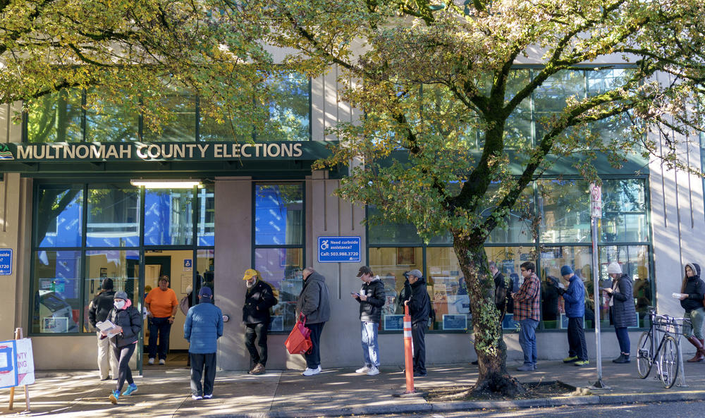 Voters wait outside of the Multnomah County Elections Division in Portland, Ore., Nov. 8, 2022.