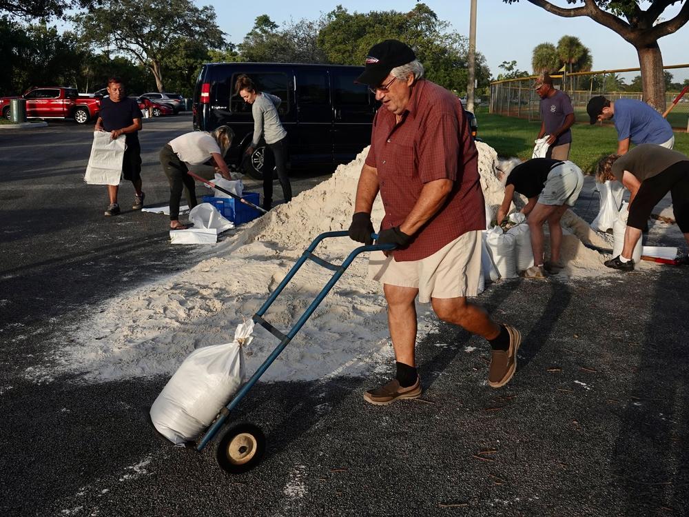 Sandbags are distributed at Mills Pond Park in Fort Lauderdale on Tuesday ahead of subtropical storm Nicole.