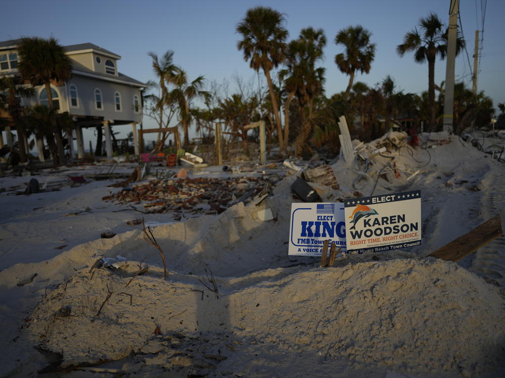 Signs promoting candidates for Fort Myers Beach town council sit along a roadside on Estero Island, which was heavily damaged in September's Hurricane Ian, in Fort Myers Beach, Fla., on Tuesday.