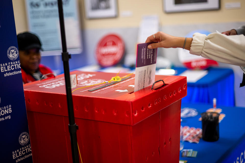 A voter drops off their ballot at the City Hall Voting Center in San Francisco on Election Day, Nov. 8, 2022.