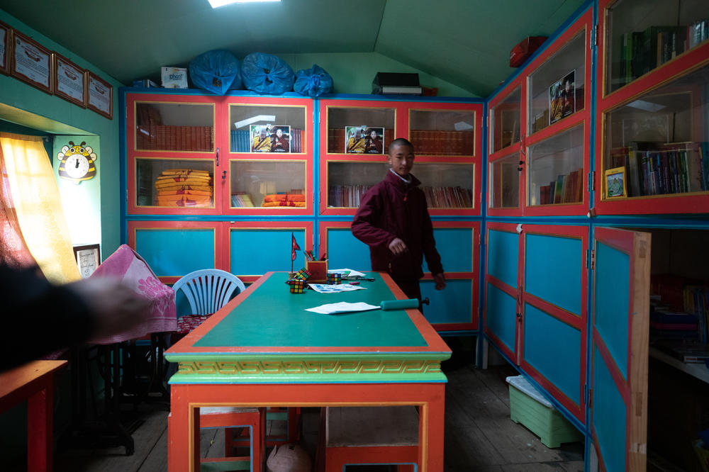 A student in the monastery school library. They study math, basic science and history as well as religion and language. The goal is to include climate change in future curricula.