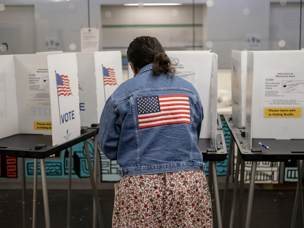 A voter casts their ballot at the Hillel Foundation on Tuesday in Madison, Wis.