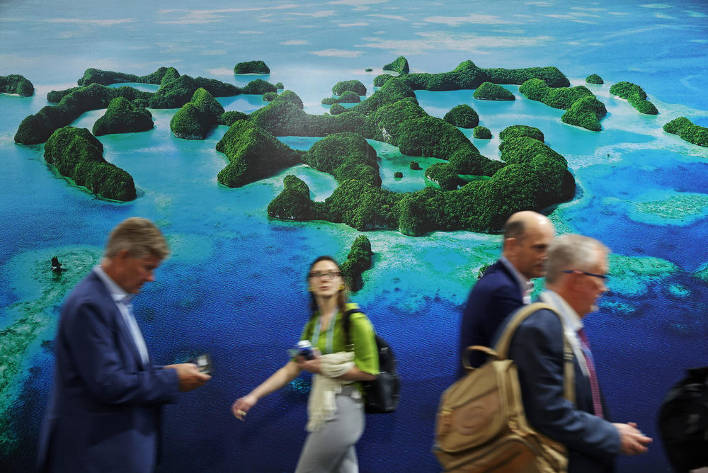 Conference attendees walk past the Mona Blue Pacific Pavilion at the conference.