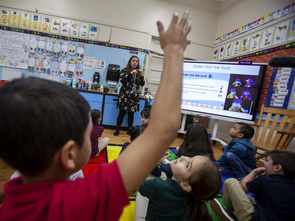 First-grade teacher Leticia Denoya uses puppets, as part of the Feel Your Best Self program developed at the University of Connecticut, to help students deal with emotions.