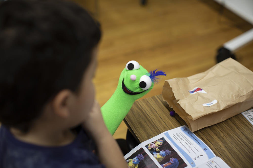 A happy-faced puppet comes alive; Just add hand! The sock is part of a build-your-own puppet kit provided to the students.