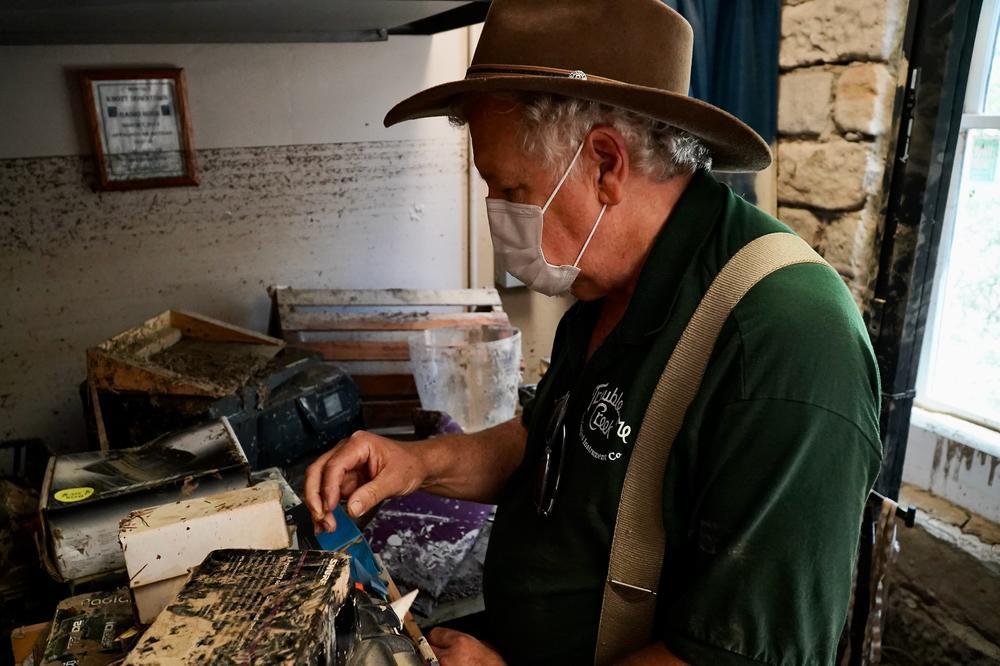 Doug Naselroad examines damaged equipment at his Appalchian School of Luthiery.