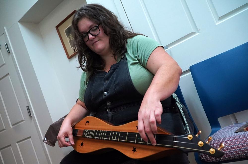 Sarah Kate Morgan, a director at Hindman Settlement School in Knott County, with her mountain dulcimer. After the floods, Morgan's role shifted from education to coordinating relief operations.