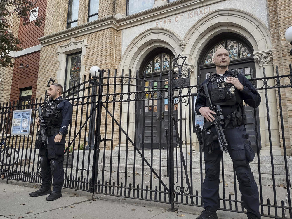 Hoboken Police officers stand watch outside the United Synagogue of Hoboken last Thursday in Hoboken, N.J.