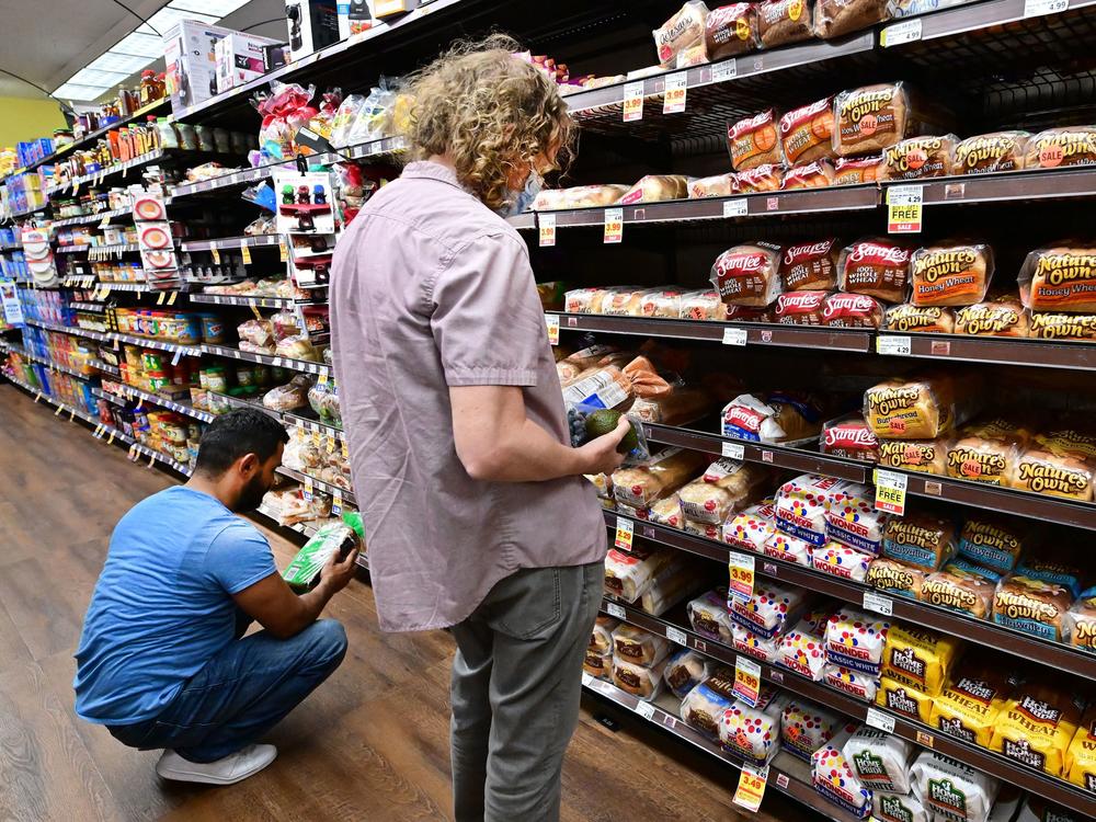 People shop for bread at a supermarket in Monterey Park, California on October 19, 2022. Grocery prices were up 12.4% last month from a year earlier, a government report showed.