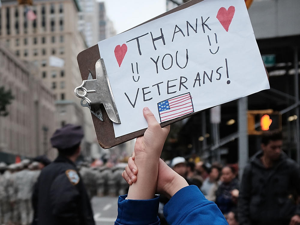 Gavin Kinney holds up a sign thanking veterans at the 2015 Veterans Day Parade in New York City.