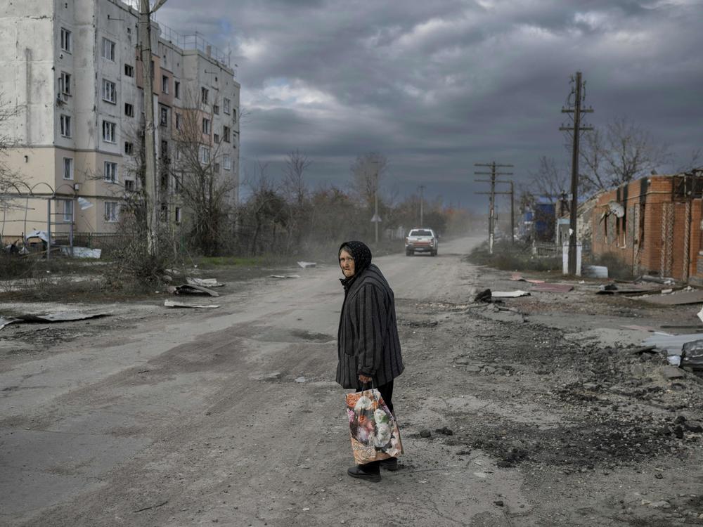 An elderly woman walks in the southern Ukrainian village of Arkhanhelske, outside Kherson, on Nov. 3. The Russians occupied the village until recently. Now Ukrainian forces are moving into villages where the Russians left. The Russians also say they're withdrawing from Kherson, marking another major setback for the Russian military.