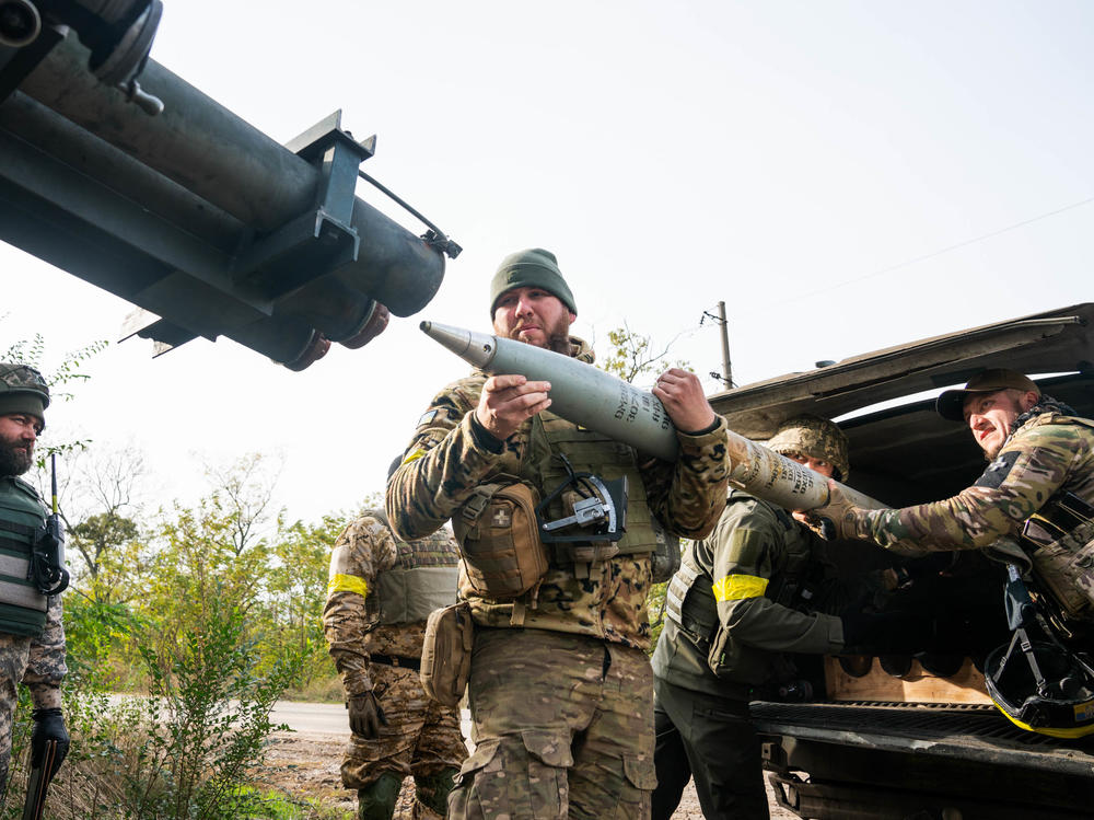 A group of Ukrainian soldiers from the Territorial Defense load a rocket under the cover of trees in Kherson Region in October. The approaching winter may force a change in tactics, Ukrainian military units and Western military analysts say.