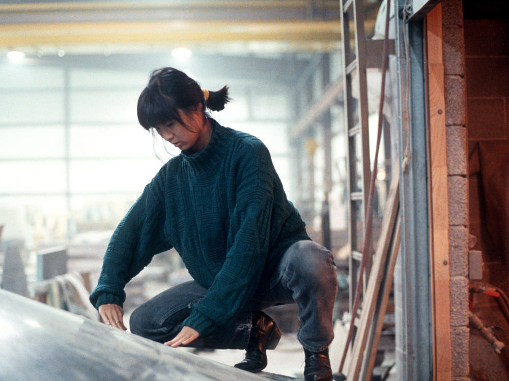 Maya Lin, in 1988, examining inverted water table being fabricated for the Civil Rights Memorial she designed to be installed in Montgomery, Alabama.