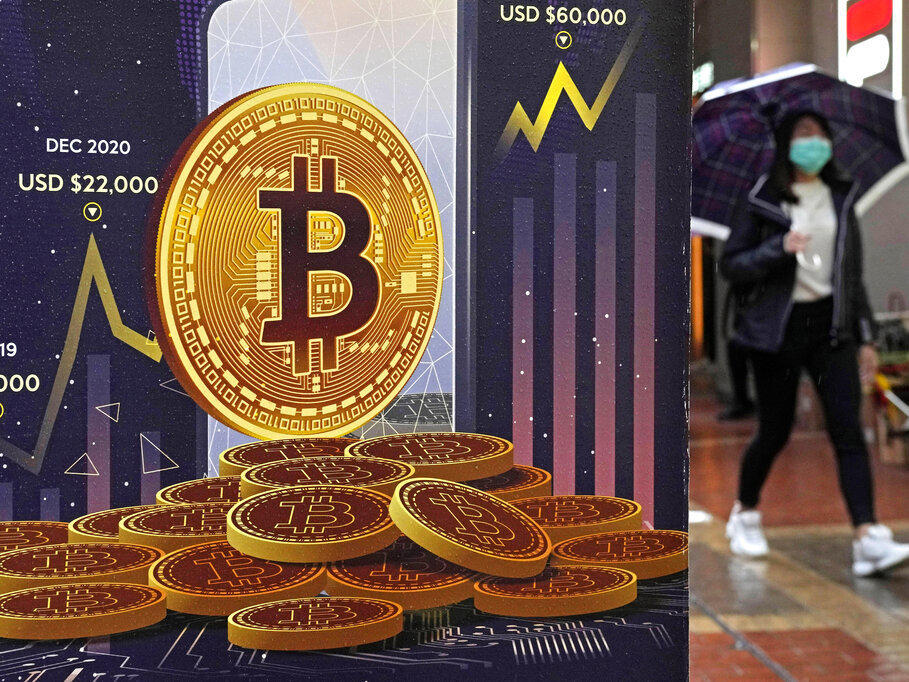 An advertisement for Bitcoin cryptocurrency is displayed on a street Feb. 17 in Hong Kong. Bitcoin slumped to a two-year low Wednesday.