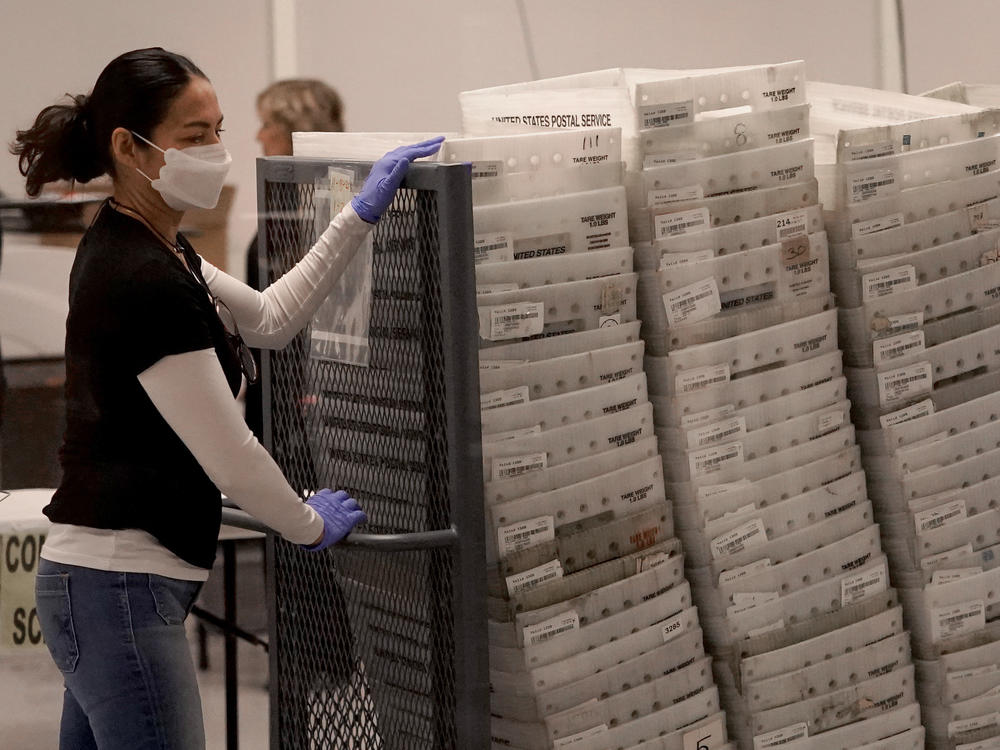 An election worker arrives with ballots to be tabulated inside the Maricopa County recorder's office in Phoenix on Wednesday.