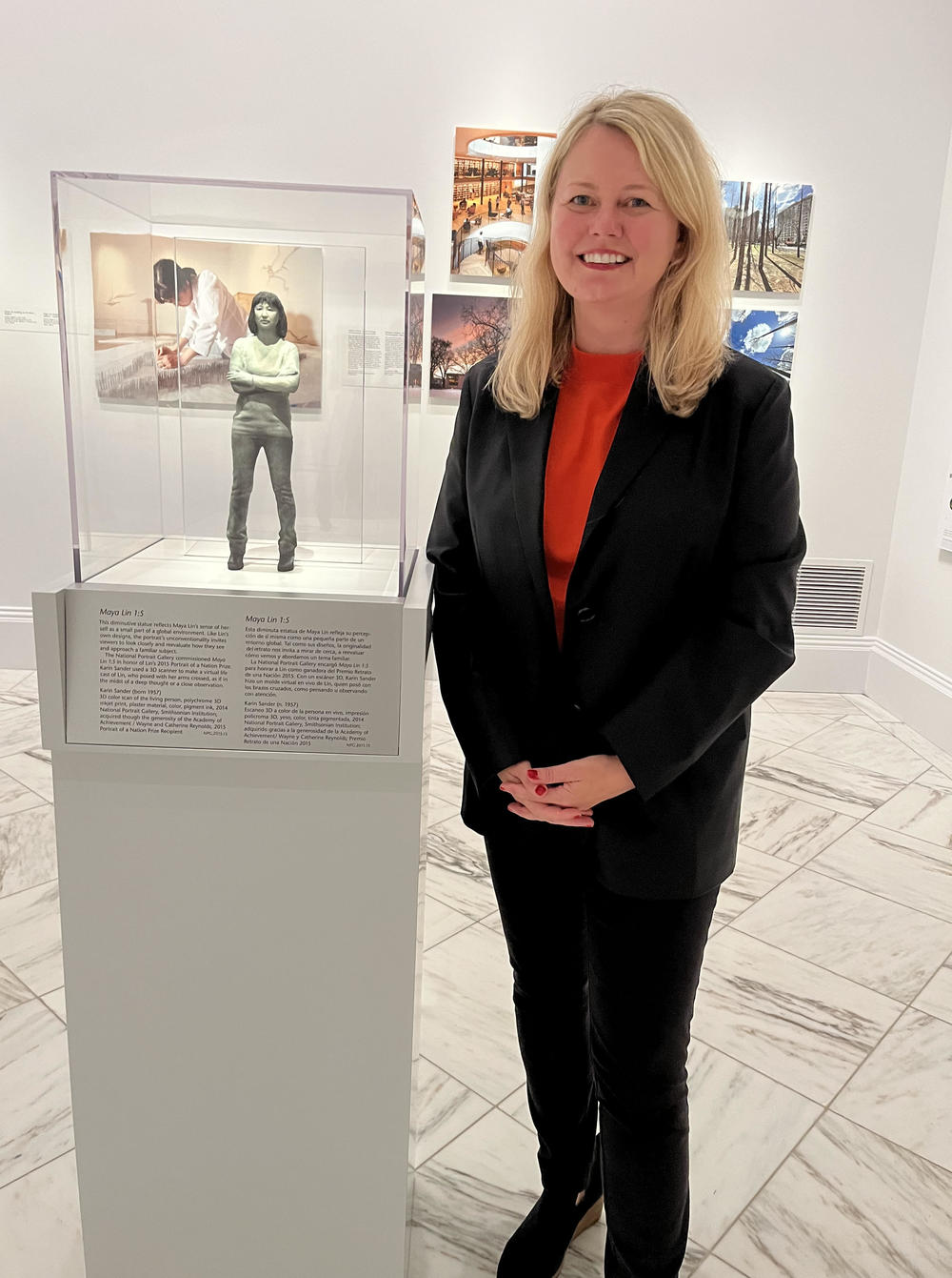 <em>One Life: Maya Lin</em> curator Dorothy Moss poses with Lin's portrait, commissioned by the National Portrait Gallery from artist Karin Sander in 2014.