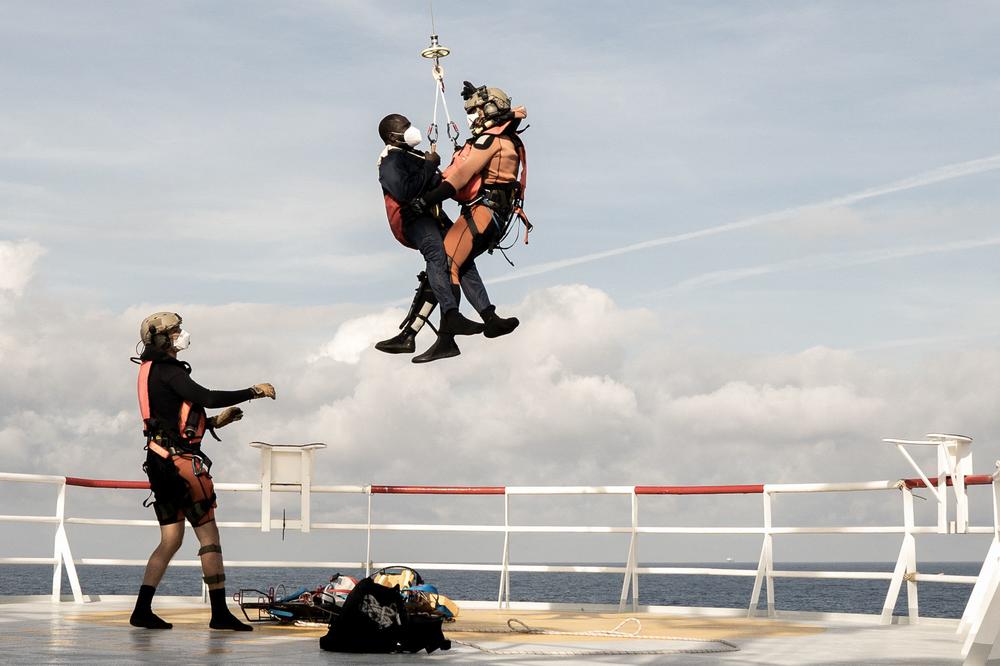 A migrant in need of urgent medical care is lifted by a helicopter by the French Army from the Ocean Viking rescue ship in the Tyrrhenian Sea on Thursday.