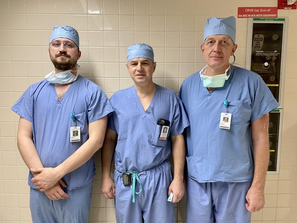 Dr. Serguei Melnitchouk (center) of Massachusetts General Hospital is training Ukrainian surgeons Volodymyr Voitko (left) and Vitalii Sokolov  (right) on how to perform heart and lung transplants so they can do them in their home country. Photo taken Nov. 17, 2022, at MGH.