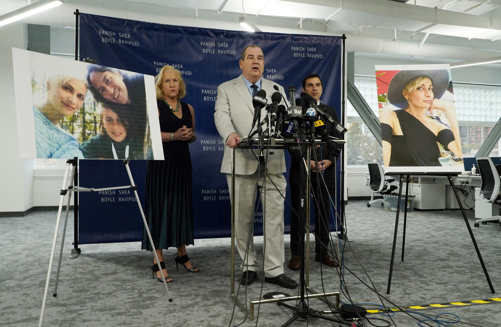 Randi McGinn, from left, Brian Panish and Jesse Creed, attorneys for the family of cinematographer Halyna Hutchins, take part in a news conference alongside portraits of Hutchins and her family, Feb. 15, 2022, in Los Angeles.