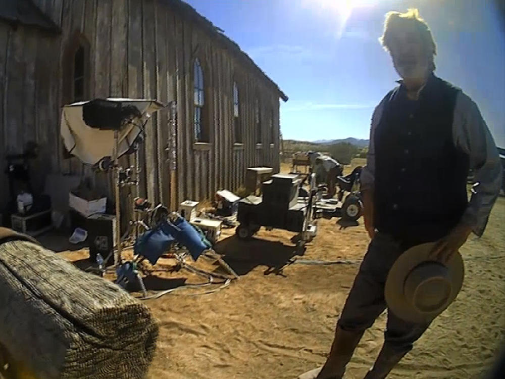 In this image from video released by the Santa Fe County Sheriff's Office, Alec Baldwin stands in costume and speaks with investigators following a fatal shooting last year on a movie set in Santa Fe, N.M.