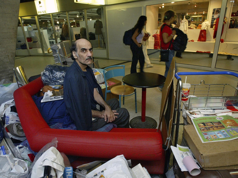 Merhan Karimi Nasseri lived for 18 years in Paris' Charles de Gaulle Airport and inspired the Steven Spielberg film <em>The Terminal</em>. He died Saturday in the airport, officials said.