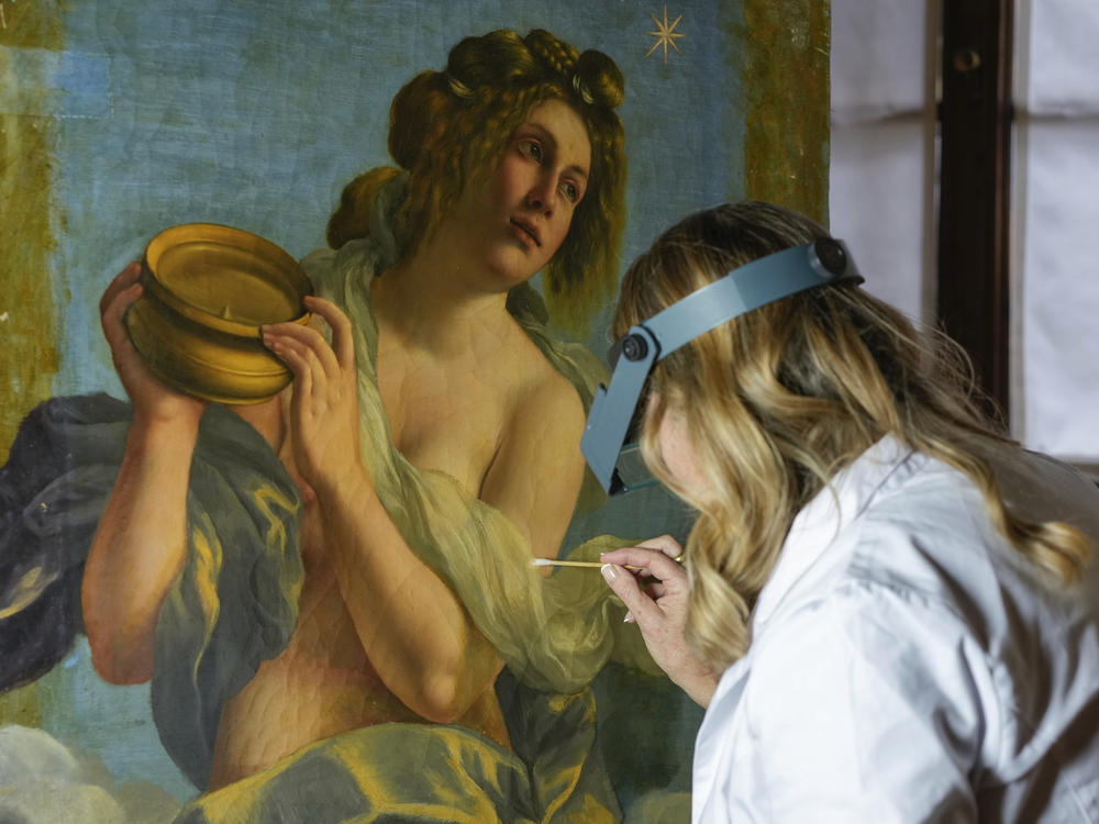 Restorer Elizabeth Wicks works on the <em>Allegory of Inclination</em>, a 1616 work by Artemisia Gentileschi, in the Casa Buonarroti Museum, in Florence, Italy, on Wednesday.