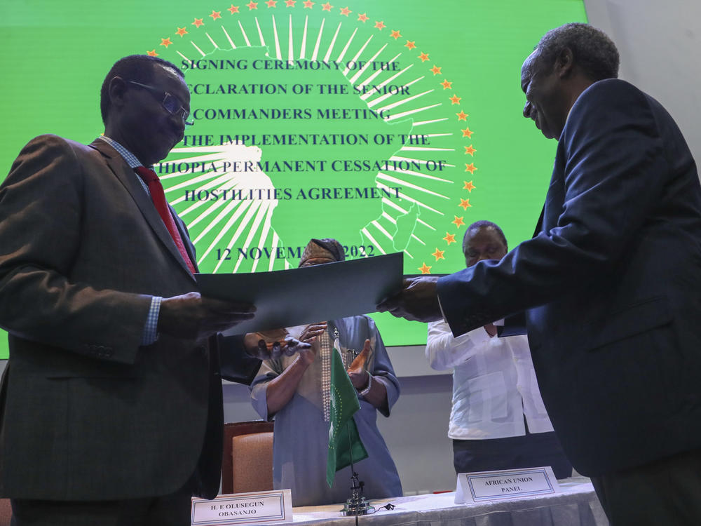 Chief of Staff of Ethiopian Armed Forces Field Marshall Birhanu Jula, left, and Head of the Tigray Forces Lt. Gen. Tadesse Werede, right, exchange signed copies of an agreement, at Ethiopian peace talks in Nairobi, Kenya, on Saturday.