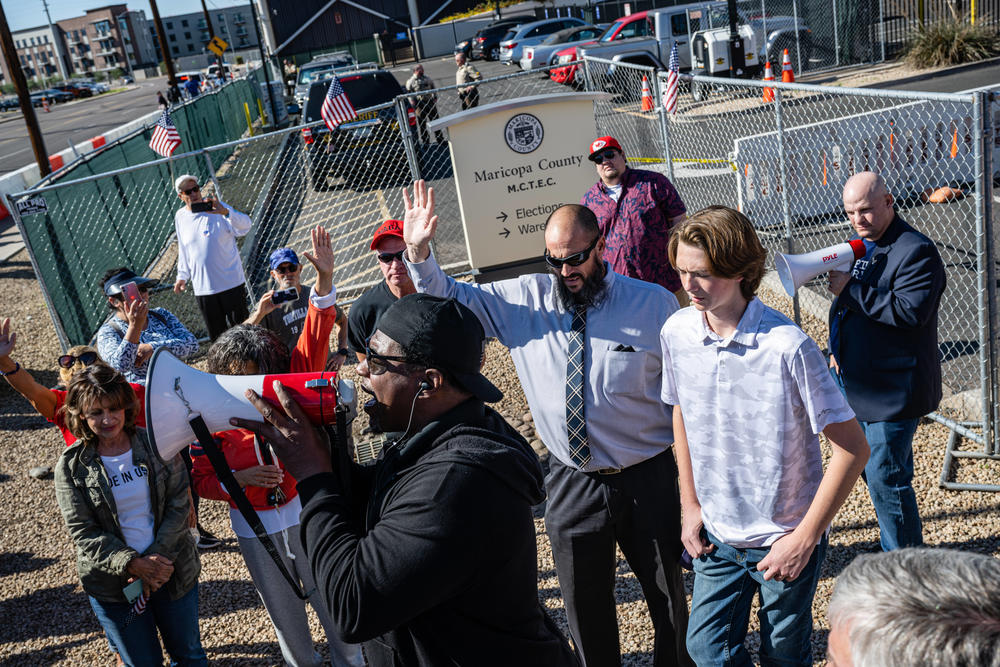 Right-wing activists protest the election process in front of the Maricopa County election center in Phoenix on Saturday. Ballots continue to be counted there as officials push back against conspiracy theories claiming the process is being delayed.