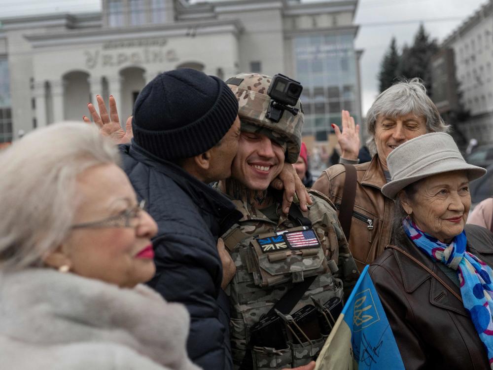 A man hugs a Ukrainian soldier as local residents gather to celebrate the liberation of Kherson on Sunday.