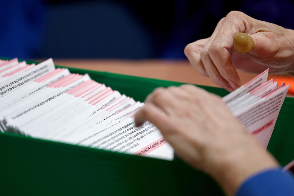 Ballots are processed by an election worker at the Clark County Election Department on in North Las Vegas on Thursday.