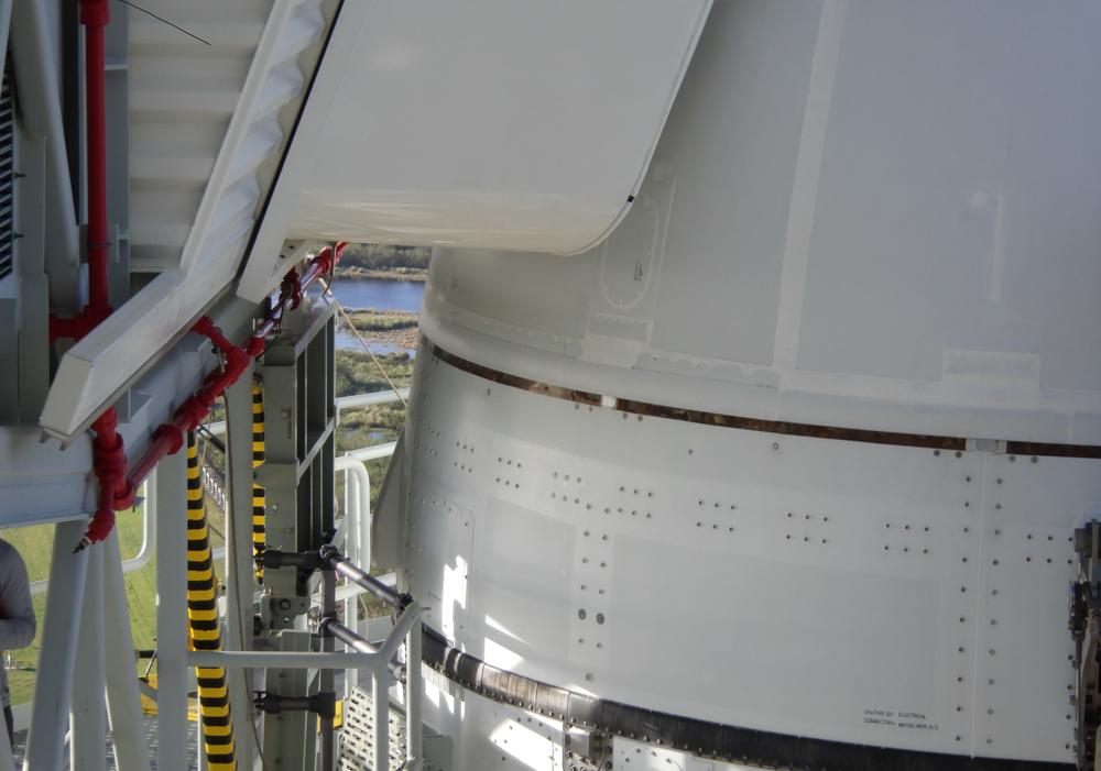 This close-up view of the rocket shows damage from Hurricane Nicole. Some caulking material, which appears as a bright white strip just above the thin black line, got torn off in the winds.