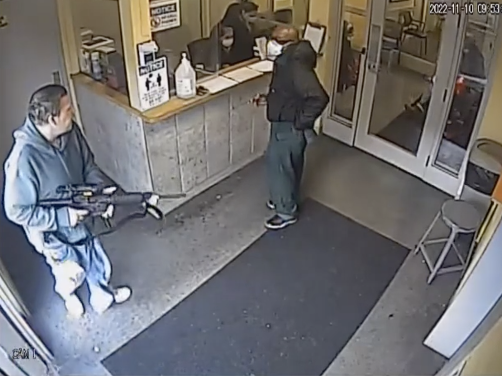 Jeremy Griffin enters the lobby of he Alba de Vida substance abuse treatment clinic holding an AR-15.