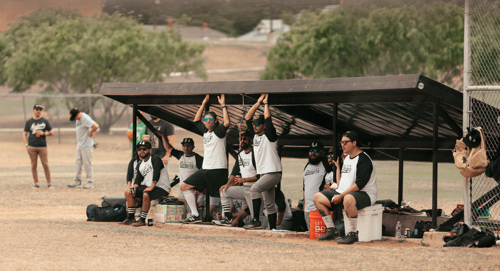 Texas Dingers players await their turns at bat.