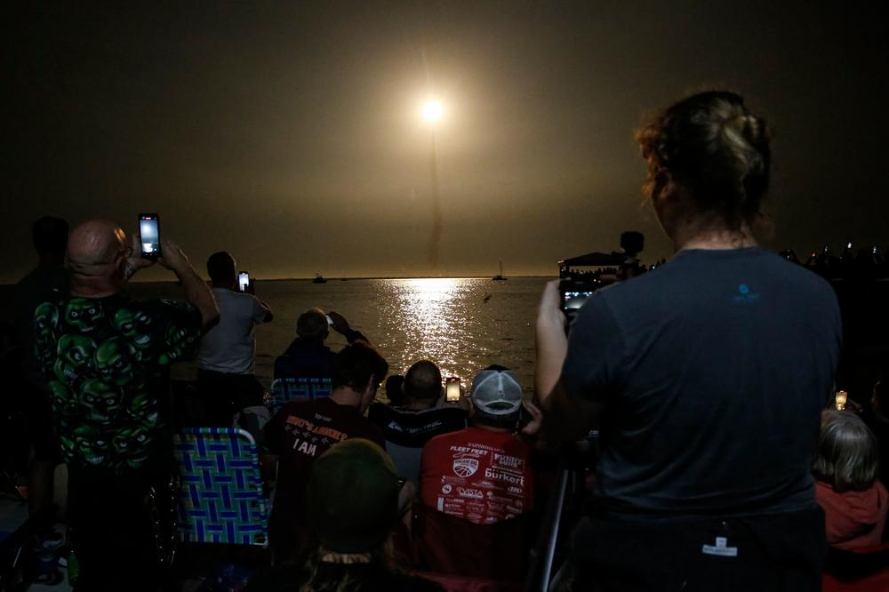 People at Veterans Memorial park watch as the Artemis I unmanned lunar rocket lifts off at NASA's Kennedy Space Center, on Nov. 16 in Titusville, Fla.