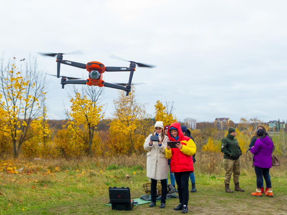 Yevhenia Podvoiska and Tatiana Kuznetsova, from left, both policewomen, steer and navigate a drone during class in Kyiv on Oct. 27. Students must learn to work in pairs: a pilot and a navigator.
