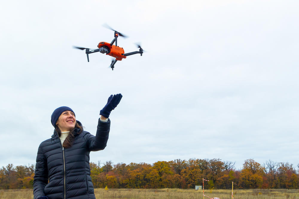 Iryna Solodchuk reaches to catch a drone mid-air as it's steered by one of her classmates in Kyiv on Oct. 27.