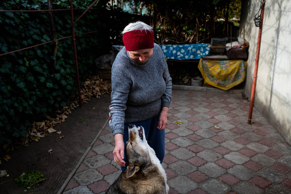 Mariya Kryvoruchko, 70, with her son-in-law's dog, Sana, in Kherson on Wednesday. Kryvoruchko describes the city under occupation as like living in a 