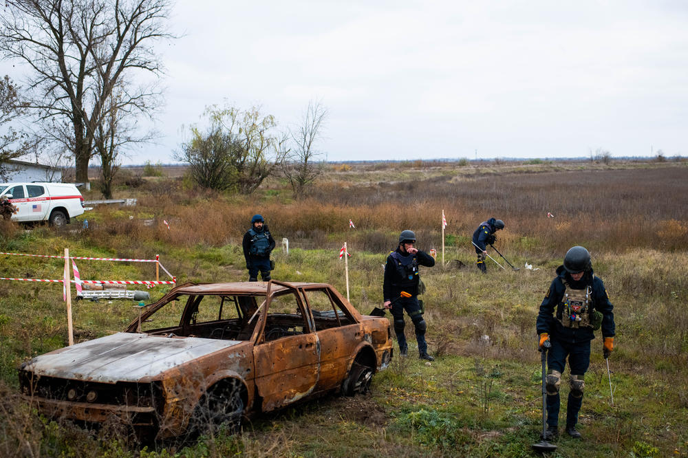 A crew from the Ukrainian State Emergency Service searches for mines and unexploded ordnance next to a highway in Posad-Pokrovske, a village halfway between Mykolaiv and Kherson city, on Wednesday.