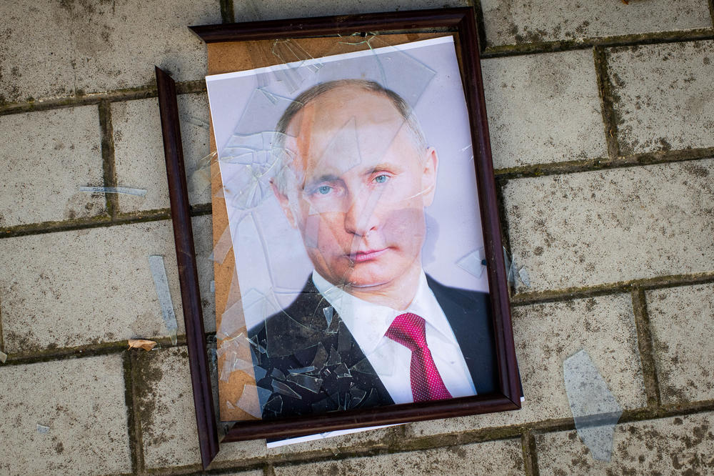 A damaged portrait of Russian President Vladimir Putin outside a police station that Kherson residents say was used by Russians as a detention and torture center.